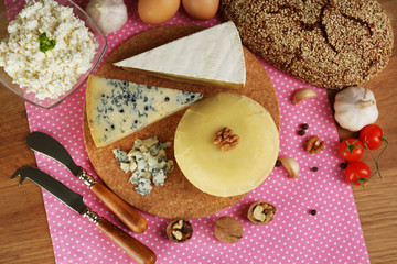 Still life with dairy products and bread on wooden table