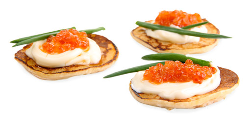 Pancakes with red caviar isolated on white