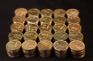 Coins stacked on a black background