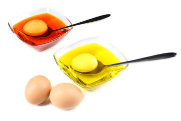 Bowls with paint for Easter eggs and eggs, isolated on white