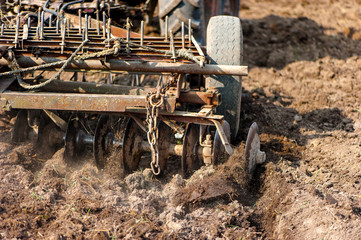 Close-up of agriculture harvesting and cultivating using a plow