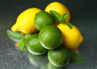 Lemons and limes on dark background