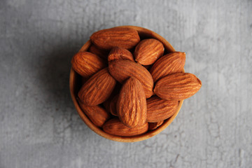 Almonds on color wooden background