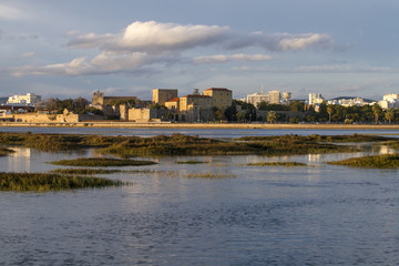 city of Faro, Portugal, creating a reflection on the water.