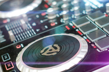 DJ turntable sound mixer in nightclub