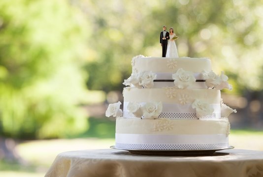 Close-up of figurine couple on wedding cake