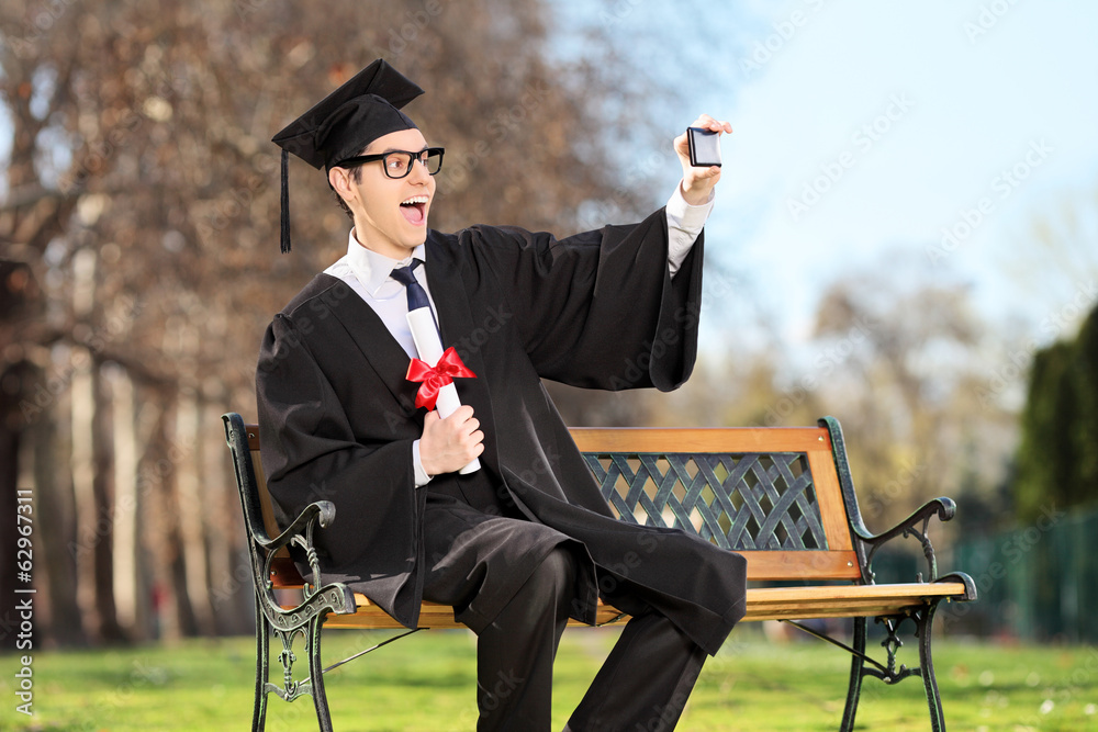 Wall mural Excited college student taking a selfie