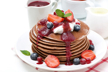 pancakes with cream and fresh berries for breakfast, isolated