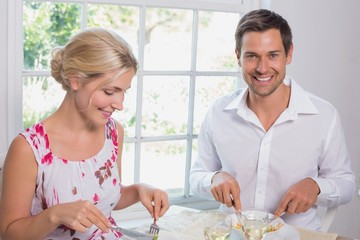 Obraz na płótnie Canvas Portrait of a happy couple having food