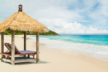 beach beds with roof and turquoise sea