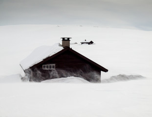 mountain huts in snow storm