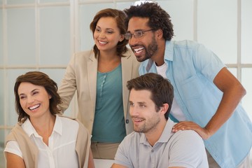 Obraz premium Smiling business people looking away at office