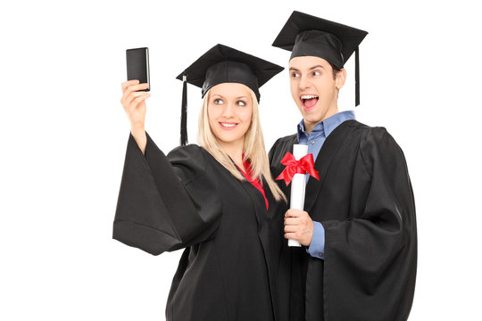 Male and female graduate students taking a selfie