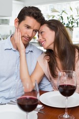 Couple with wine glasses at dining table