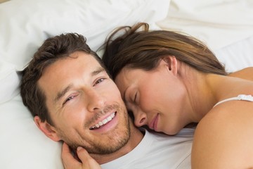 Close-up of a loving couple lying in bed