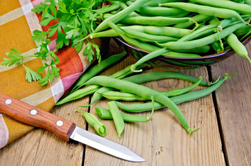 Beans green on board with knife and napkin