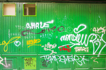 Graffiti on a green wooden wall