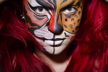 Woman with face painting in dark room