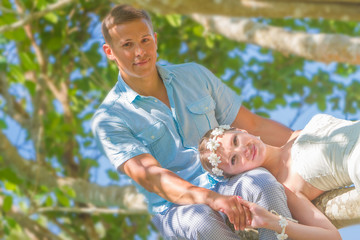 young happy loving couple on natural background