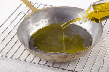 olive oil is poured into a pan