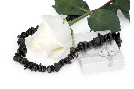 necklace from black agate round a white rose, and a gift