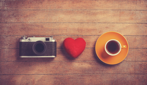 Camera, red heart and cup of a coffee.
