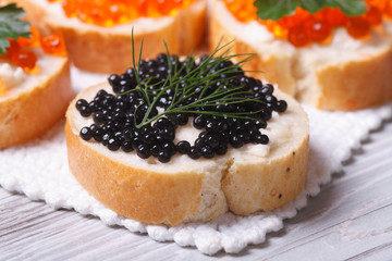 Sandwiches with black caviar fish macro