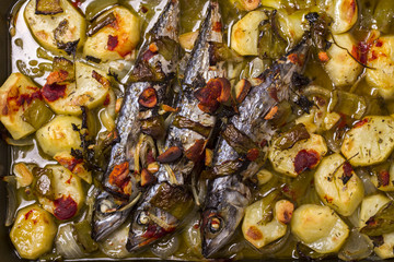 Close up view of cooked mackerel fish with potato.