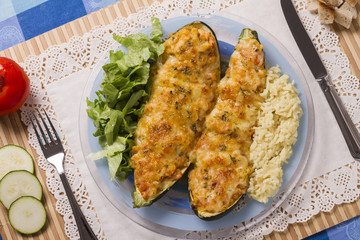 meat and vegetables zucchini halves with rice