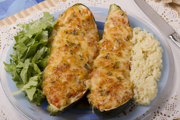 meat and vegetables zucchini halves with rice
