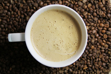 Coffee cup on coffee bean background