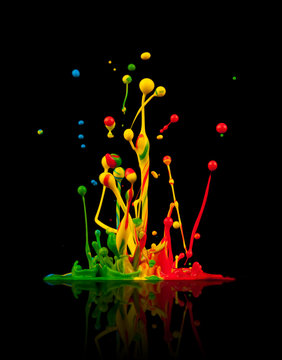 Colored paint splashes on black background