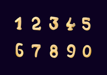 Funny numerals from cereal products isolated on black
