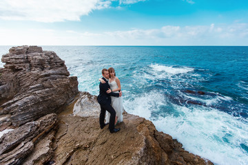 Bride and groom near the ocean