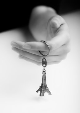 Fototapeta Female Hand Holding Souvenir of the Eiffel Tower. Studio Shot