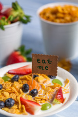 Enjoy your breakfast with cornflakes and fruits