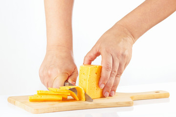 Hands sliced cheese on a cutting board close up