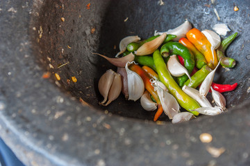 Peppers, garlic in a mortar