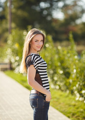 Obraz premium Portrait of a young beautiful smiling blonde woman outdoors