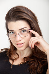 close up of beautiful young woman with eyeglasses