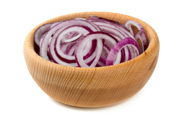 red onion slices in a wooden bowl isolated on white