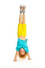 Blond boy standing on hands