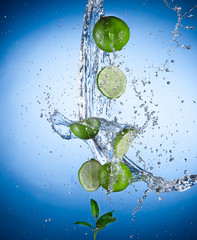 Fototapeta na wymiar Limes with water splash