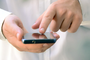 Close up of a man using mobile smart phone