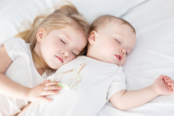 charming little brother and sister asleep