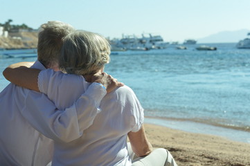 Amusing elderly couple on a beach