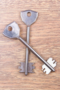two metal keys on wooden table