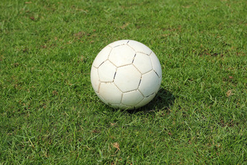 Fototapeta na wymiar old soccer ball on field
