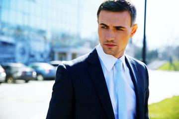 Fototapeta premium Portrait of a pensive businessman on the street