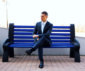 Portrait of a businessman sitting on bench